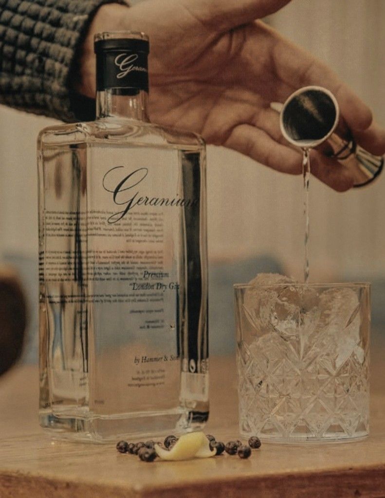 Geranium Gin poured from the bottle into a glass.