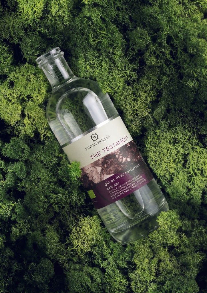The Testament Organic Gin bottle on a forest bed of moss.